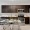 a kitchen with dark cabinets and a dining table