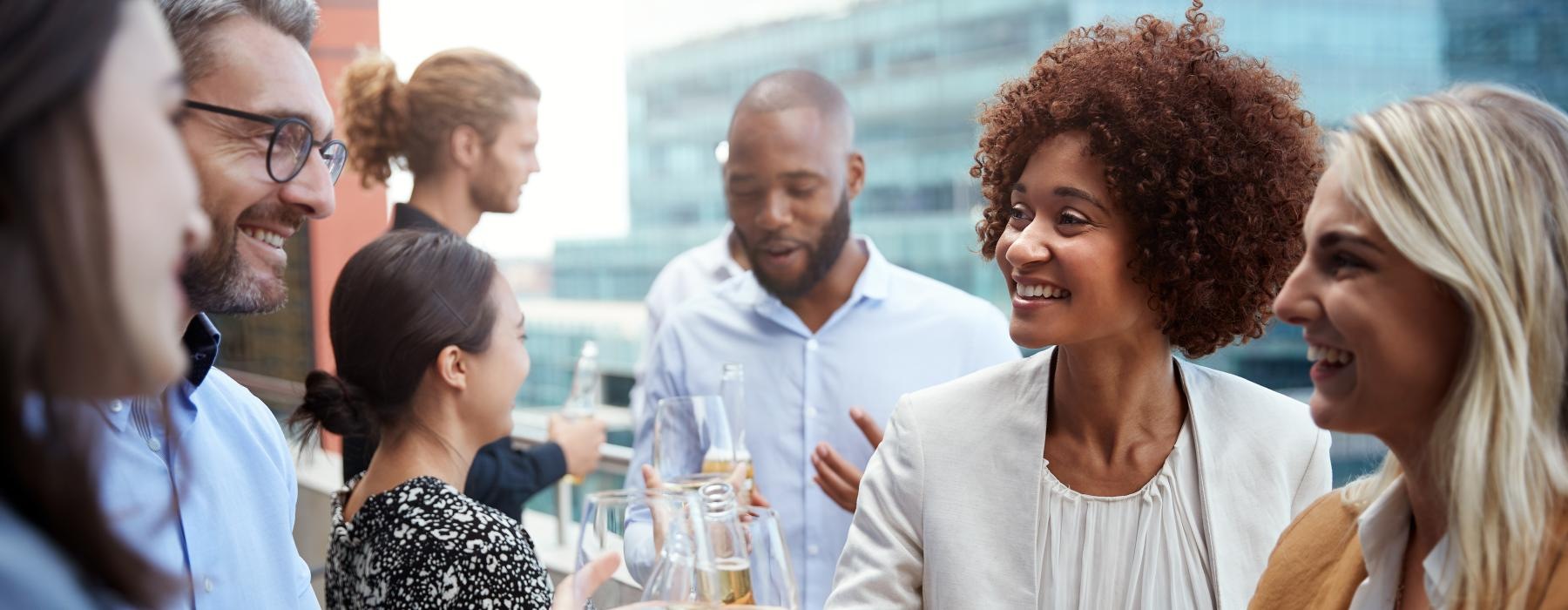 Find your perfect fit at District West Gables a group of people having a conversation with wine