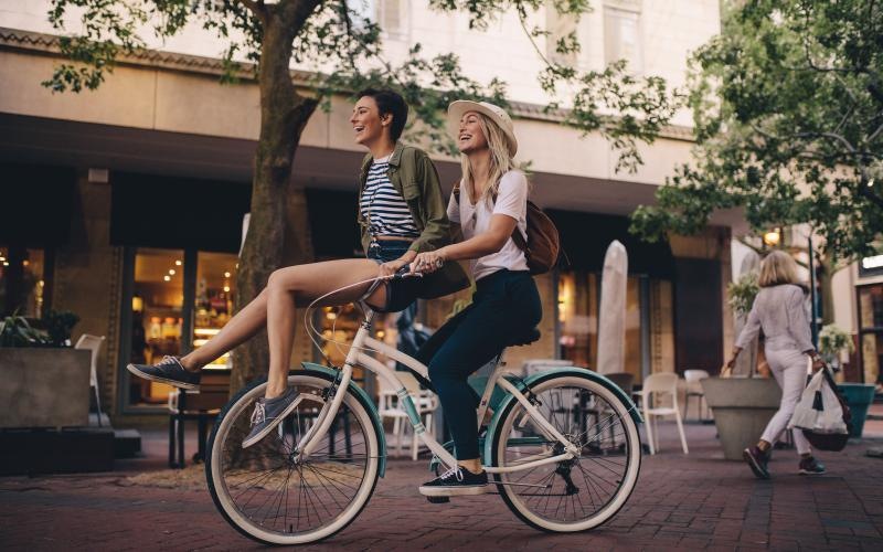The essence of exceptional living women riding a bicycle together