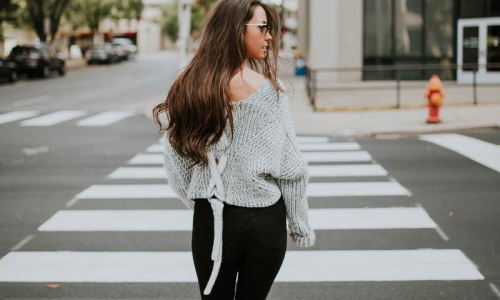 Close to the center of everything a person walking in a crosswalk