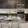 a kitchen with dark cabinets and a dining table and chairs