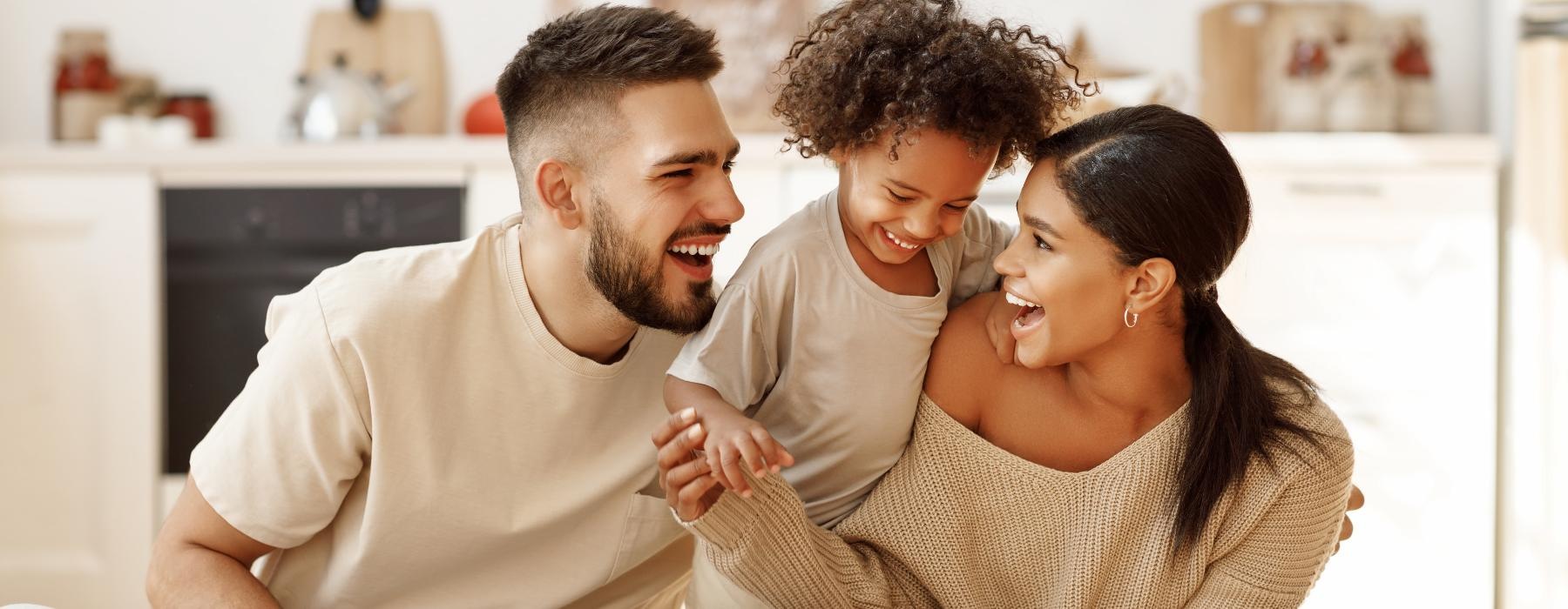 Settle into comfort at District West Gables a family sitting on the floor