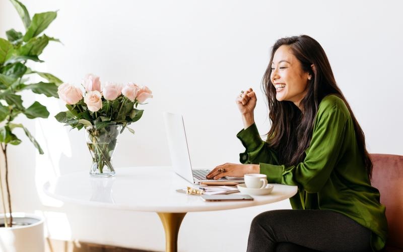 Find your perfect fit at District West Gables a woman sitting at a table with a computer